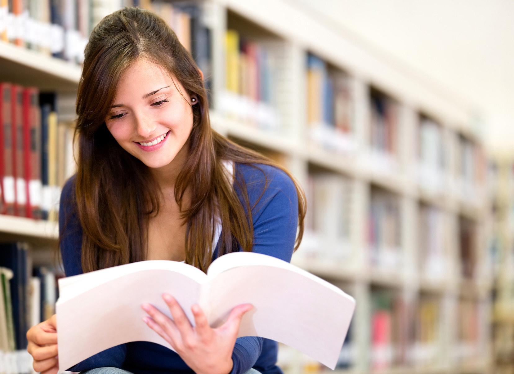 woman reading a book in library