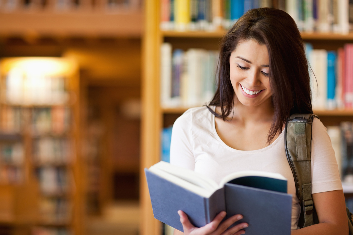 Cute student reading a book - Wayland Free Public Library