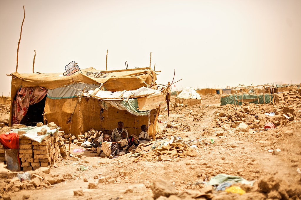 Family living in temporary structure after their house has been demolished. They have prepared some bricks to reconstruct the house as soon as the rains begin, which should be shortly. Rains normally bring floods to the area with consequent serious health risks to affected families.